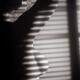 Art nude black and white portrait of a woman standing in light coming... (thumbnail)