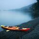 Red kayak on the shore of Salish sea in yearly misty morning at Vancou... (thumbnail)