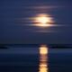 Red Full Harvest Moon rising above Pacific ocean in autumn... (thumbnail)