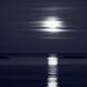 Full Harvest Moon rising above Pacific ocean in autumn Black and white... (thumbnail)