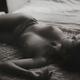 Candid nude portrait of a beautiful young naked woman lying relaxed in... (thumbnail)