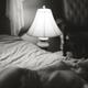 Beautiful naked woman lying on bed in dim light night lamp Candid art... (thumbnail)