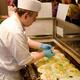 Street food vendor cooking Okonomiyaki pancakes at Nishiki market in J... (thumbnail)