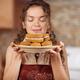 Woman enjoying smell of fresh home-made baked cookies in the kitchen... (thumbnail)