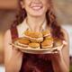 Smiling woman with a plate of freshly baked home-made cookies... (thumbnail)