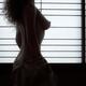 Nude woman undressing by a shoji window naked body silhouette in brigh... (thumbnail)