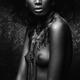 Artistic black and white nude native woman breast with a feather neckl... (thumbnail)