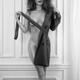 Black and white portrait of a sexy stylish woman in glasses taking off... (thumbnail)