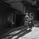 Two Maiko in kimono walking down an old street in Kyoto Japan Black an... (thumbnail)