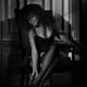 Black and white sexy boudoir portrait of a woman sitting in a chair in... (thumbnail)