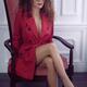 Sexy woman in a red trench coat and large eye glasses with an expressi... (thumbnail)