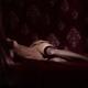 Fine art nude photo a woman in black stockings lying naked on bed with... (thumbnail)