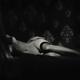Fine art nude black and white photo a woman in stockings lying naked o... (thumbnail)