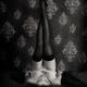 Woman lying on a bed in lingerie with sexy long legs in stockings up a... (thumbnail)