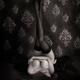 Woman lying on bed in lingerie with arms around her chest and legs in... (thumbnail)