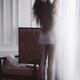 Young woman in underwear with bare legs standing on tiptoes stretching... (thumbnail)