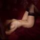 Fine art nude body figure of a woman in stockings lying down in bed na... (thumbnail)