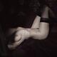 Beautiful nude woman with sensual body in black stockings lying in bed... (thumbnail)