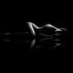 Nude woman body outline lying on black reflective background black and... (thumbnail)