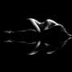 Nude body outline of a woman lying curled-up black and white... (thumbnail)