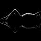 Nude woman lying on black background with a mirrored reflection... (thumbnail)