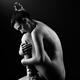 Woman ballet dancer sitting nude curled up... (thumbnail)