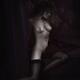 Beautiful nude woman in stockings sitting naked on a bed sensual black... (thumbnail)