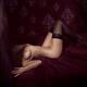 Sensual body of a woman lying in bed naked wearing only black stocking... (thumbnail)