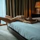 Sexy young woman lying naked on the edge of a bed with her chest arche... (thumbnail)