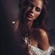 Expressive sensual portrait of a beautiful woman with feather boa arou... (thumbnail)