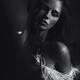 Expressive black and white portrait of a beautiful woman with feather... (thumbnail)
