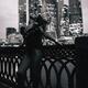 Sexy woman standing outdoors by the waterfront with a city skyline vie... (thumbnail)