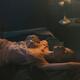 Sensual romantic photo of a woman in lingerie on a bed in dim light ge... (thumbnail)