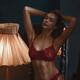 Sexy young woman with fit slim body wearing red lacy lingerie in dim l... (thumbnail)