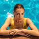 Sexy young woman with an expressing look on the side of a swimming pool