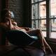 Sexy young woman sitting naked in a chair by the window... (thumbnail)