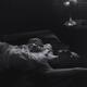 Woman in lingerie on a bed in dim light gently caressing herself Black... (thumbnail)