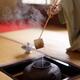 Japanese tea ceremony master pouring steaming water from a kettle with... (thumbnail)