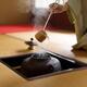 Japanese woman tea ceremony master pouring hot water from a pot with a... (thumbnail)