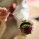 Tea ceremony master holding a bamboo spoon Chashaku of matcha green te... (thumbnail)