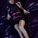 Sensual boudoir portrait of a woman lying on bed in a slick vinyl PU d... (thumbnail)