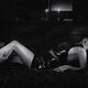 Men hands caressing a woman lying on a bed in sexy black leather dress... (thumbnail)
