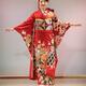 Japanese woman in a beautiful red kimono with long sleeves and golden... (thumbnail)