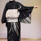 Back of a Japanese woman wearing elegant black kimono with obi at fash... (thumbnail)