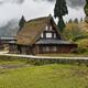 Historic Japanese Gasshou house and rice paddies in a foggy rural scen... (thumbnail)