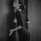 Sensual portrait of a woman in black dress revealing her bare breast l... (thumbnail)