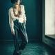 Young woman standing topless in an empty room with her shirt unbuttone... (thumbnail)