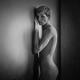 Expressive portrait of a nude woman with short hair standing against b... (thumbnail)
