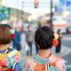 Two Japanese girls in bright Yukatas and colorful flowers in their hai... (thumbnail)