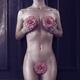 Nude woman with pink camellia flowers covering her naked body natural... (thumbnail)
